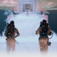 The original Ghostbusters standing on the rooftop in a flood of mist as Gozer and the terror dogs sit atop a makeshift throne.